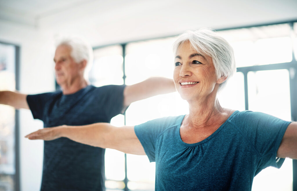 senior couple exercising together indoors